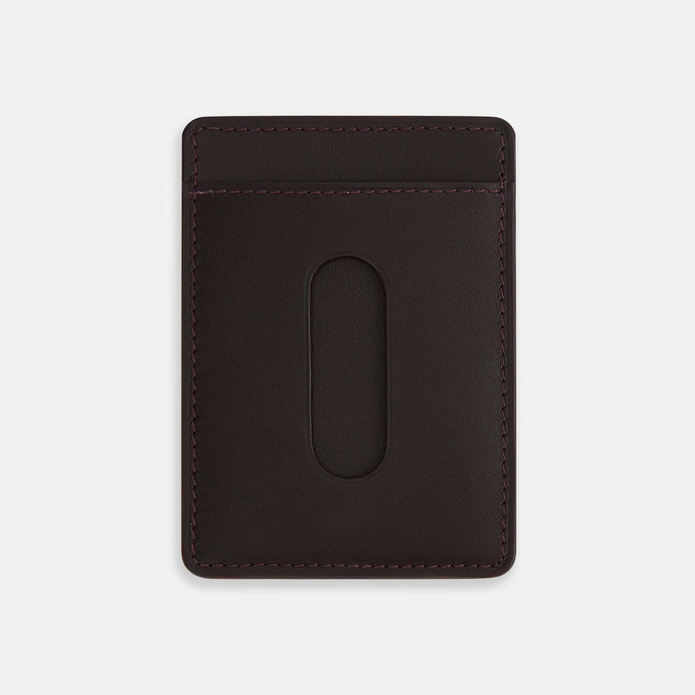 The Burgundy Two-slot Card Case by Turnbull & Asser features rich Italian leather with subtle maroon stitching and the brand embossed in white at the bottom, offering a refined minimalist accessory against a plain white background.