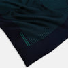View 2 of product A Navy and Petrol Green Stripe Silk Pocket Square by Turnbull & Asser, featuring thin petrol green stripes and "Turnbull & Asser Hand Printed in England" in the bottom right corner. One corner is folded to display hand-rolled edges.