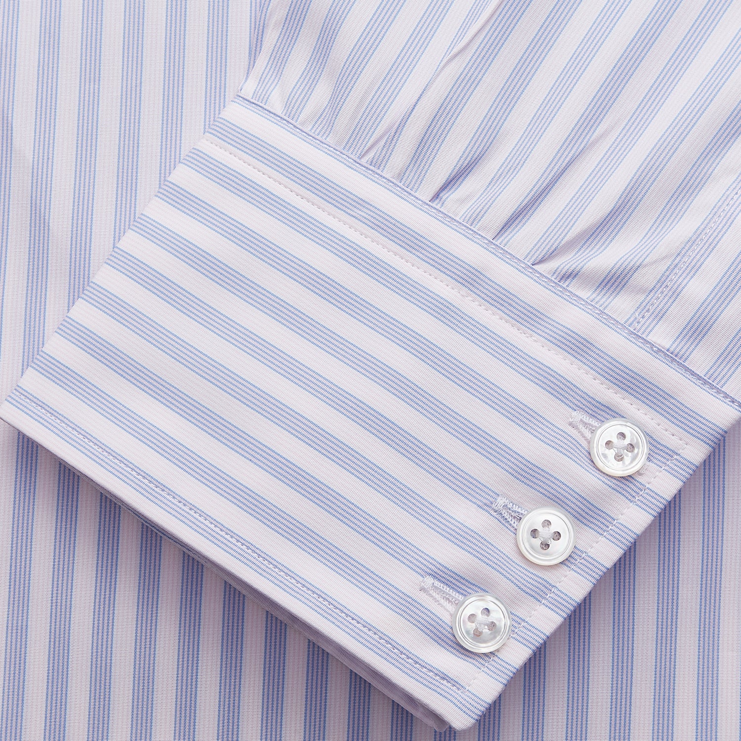 View 2 of product The Turnbull & Asser Lilac Stripe Cotton Regular Fit Mayfair Shirt features thin white and lilac stripes, a T&A collar, and buttoned cuffs, shown laid flat on a white background.