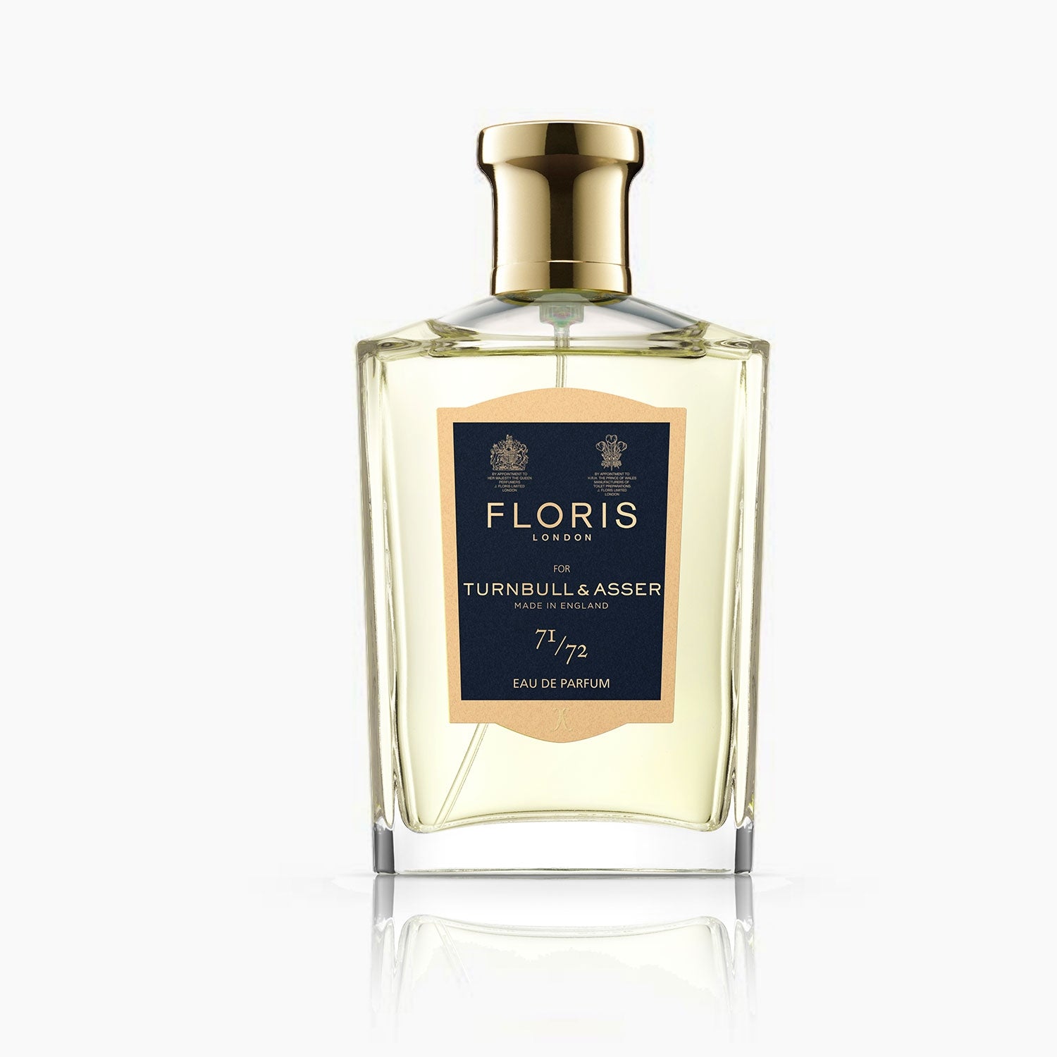 View 2 of product A bottle of Floris 71/72 Eau De Parfum by Turnbull & Asser, a woody aromatic scent, stands beside its navy blue and gold box. The 100 ml bottle features a gold cap in this exclusive collaboration.