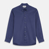 View 1 of product The Blue Piece Dyed Weekend Fit Suffolk Shirt by Turnbull & Asser features a button-down Dorset collar, chest pocket, white buttons, and long sleeves in classic navy, laid flat against a white background.