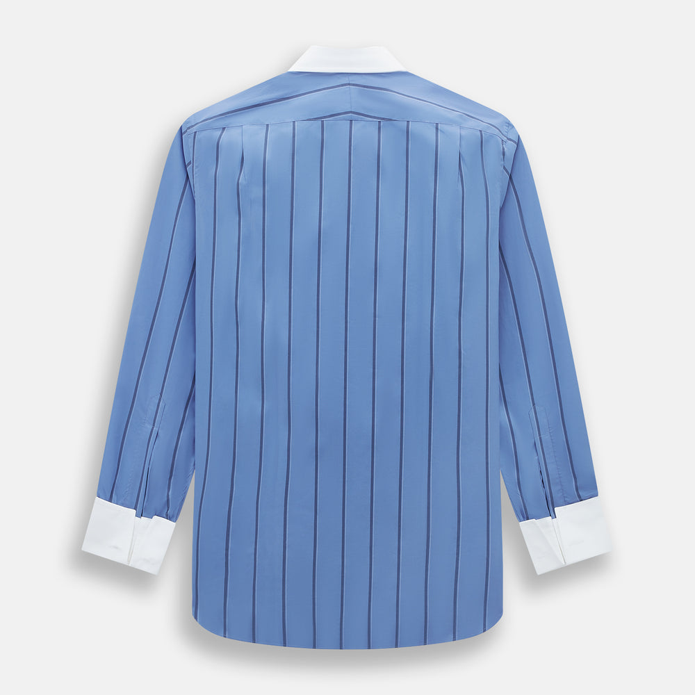The Turnbull & Asser Colony Blue Track Stripe Shirt features vertical dark blue stripes, a Mayfair fit, and contrast white T&A collar and cuffs, reflecting British craftsmanship against a plain light background.