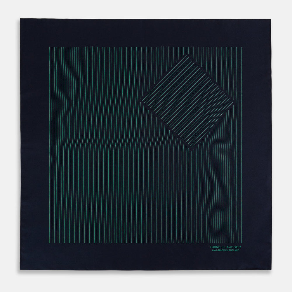 The Turnbull & Asser Navy and Hunter Green Stripe Silk Pocket Square features thin green stripes, hand-rolled edges, and "TURNBULL & ASSER HAND PRINTED IN ENGLAND" in green on the bottom right corner.