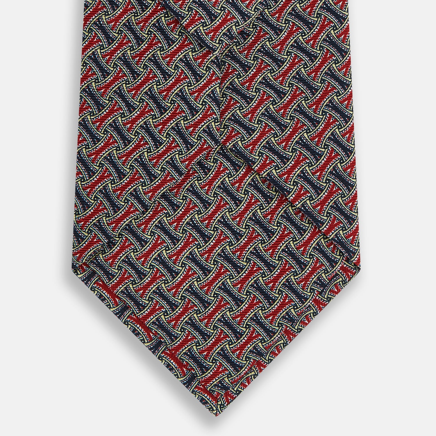 View 3 of product A close-up of the Turnbull & Asser Red and Navy Weave Patterned Silk Tie, showcasing its geometric design in red, blue, white, and yellow on a white background.