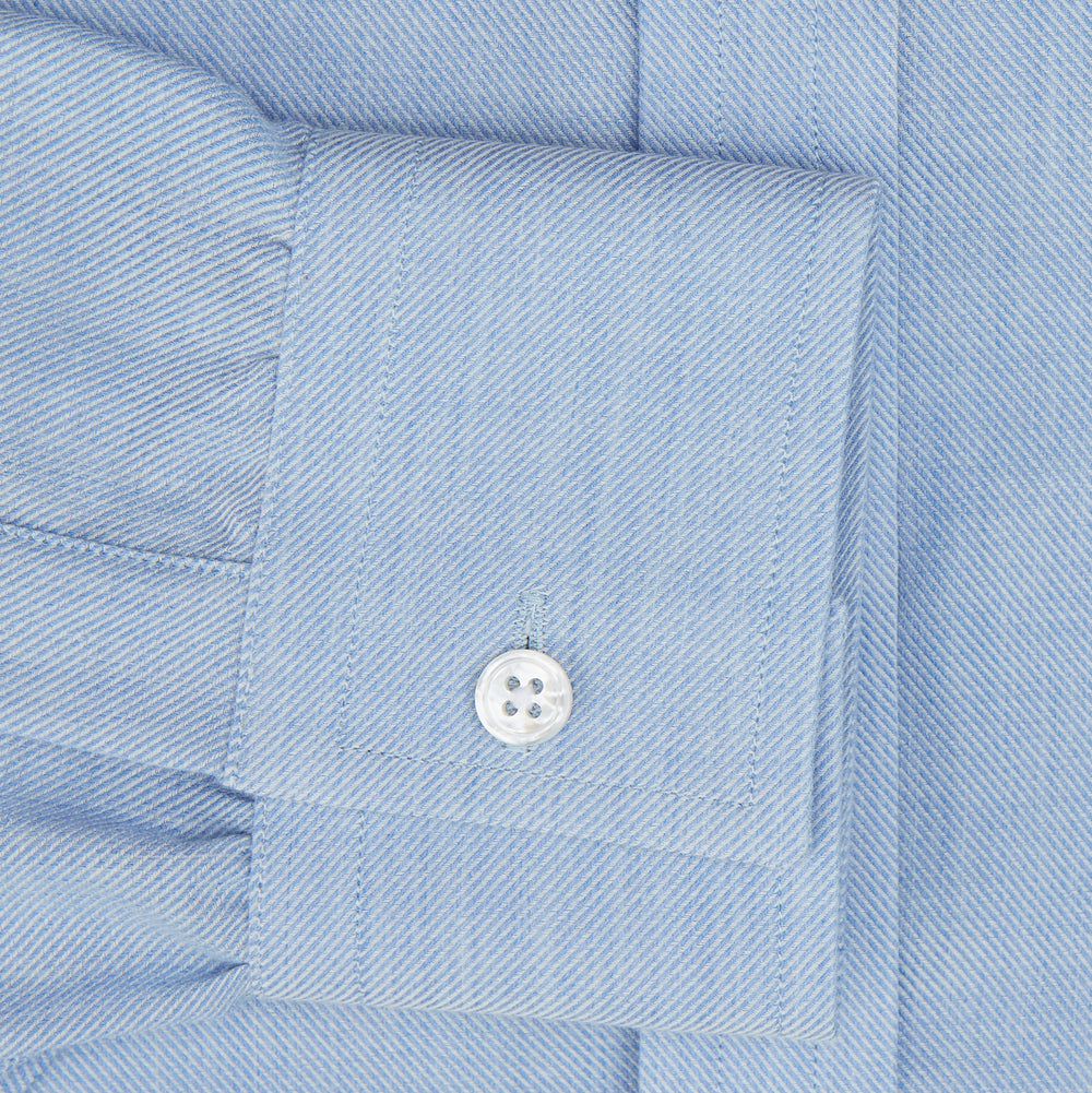 The Turnbull & Asser Pale Blue Cotton Cashmere Dorset Collar Richmond Shirt features long sleeves, a button-down collar, white buttons, and a chest pocket. It is neatly displayed flat on a white background.