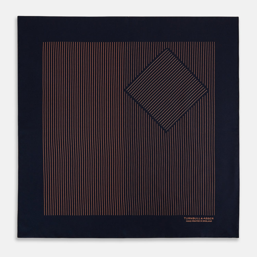 The Turnbull & Asser Navy and Blush Stripe Silk Pocket Square features thin blush stripes on navy silk, finished with "TURNBULL & ASSER HAND PRINTED IN ENGLAND" in the corner, highlighting its refined English craftsmanship.