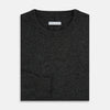 View 4 of product The Turnbull & Asser Dark Grey Cashmere Round Neck Jumper features a classic, plain long-sleeve design and is displayed on a white background.