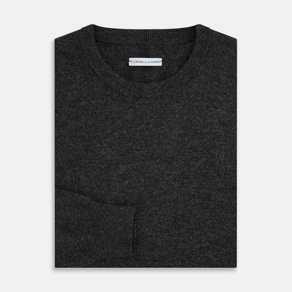 The Turnbull & Asser Dark Grey Cashmere Round Neck Jumper features a classic, plain long-sleeve design and is displayed on a white background.
