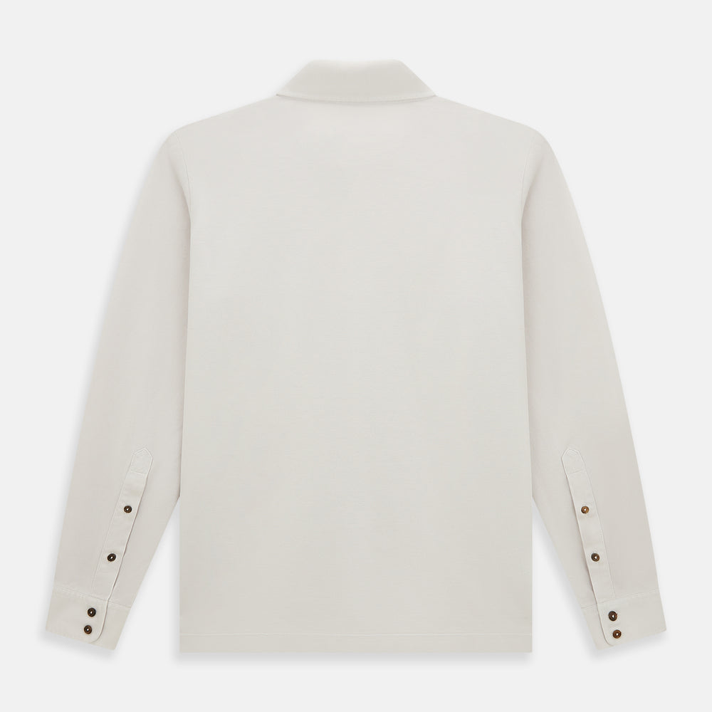 A pale pink luxury cotton rugby polo shirt by Turnbull & Asser, featuring long sleeves and a collar with no buttons, displayed flat on a white background.