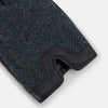 View 2 of product Turnbull & Asser Navy Herringbone Tweed Cashmere-Lined Leather Gloves are shown on a white background: one glove features dark navy herringbone tweed, the other shows a smooth black leather palm.