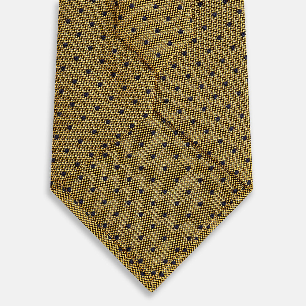 The Turnbull & Asser Purple and Yellow Micro Dot Silk Tie, featuring a refined micro-dot pattern, is a timeless men's accessory.