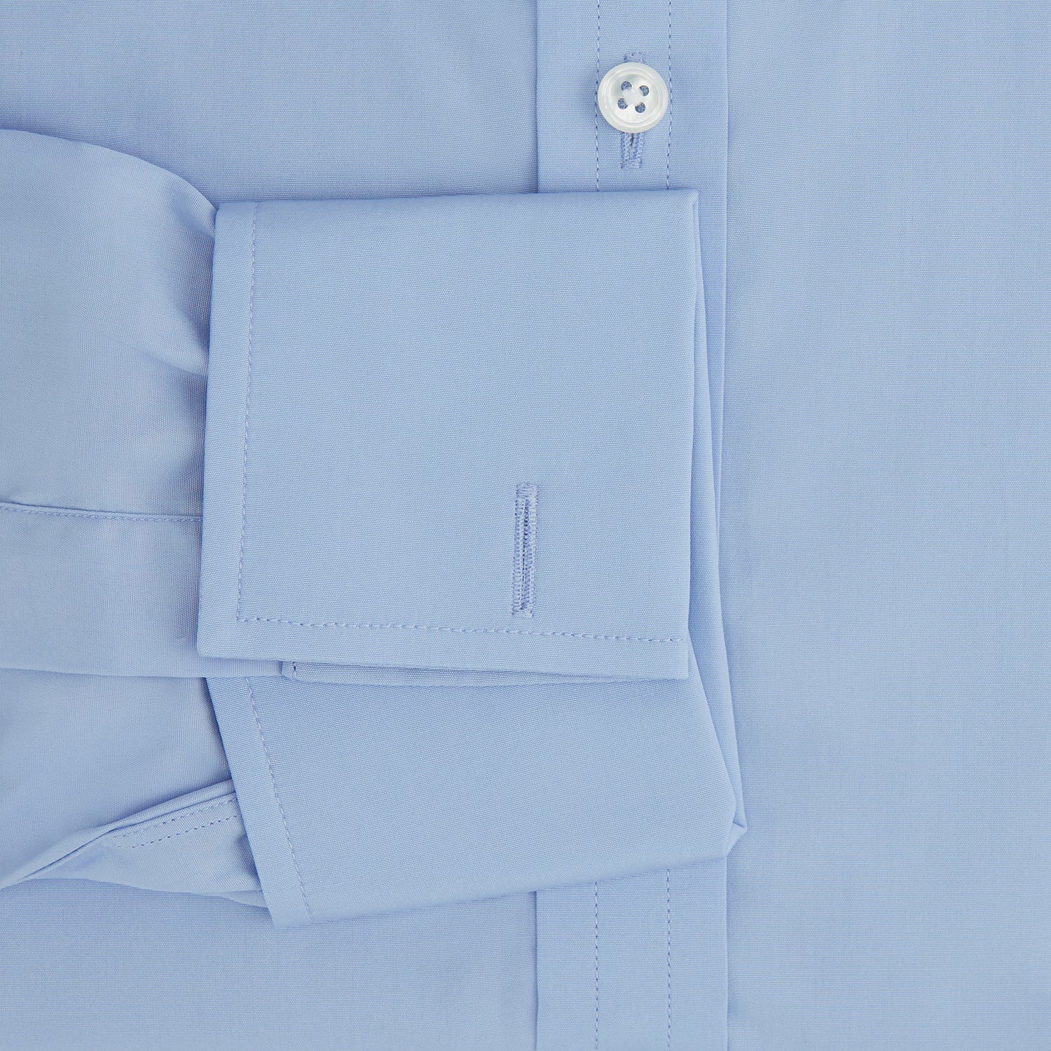 View 4 of product The Turnbull & Asser Blue Cotton Shirt features a T&A collar, double cuffs, and white buttons. This classic formal shirt is perfect for any gentleman and pairs effortlessly with a navy suit. Displayed on a plain white background.