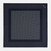 View 4 of product The Turnbull & Asser Navy and Light Blue Dot Silk Pocket Square features white polka dots, a contrasting border, and an inner square design, showcasing handmade craftsmanship with its expertly folded finish.