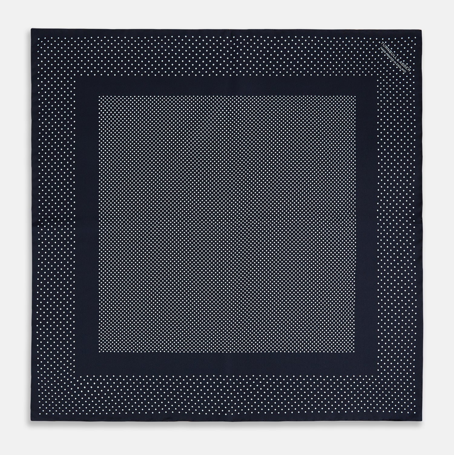 View 4 of product The Turnbull & Asser Navy and Light Blue Dot Silk Pocket Square features white polka dots, a contrasting border, and an inner square design, showcasing handmade craftsmanship with its expertly folded finish.