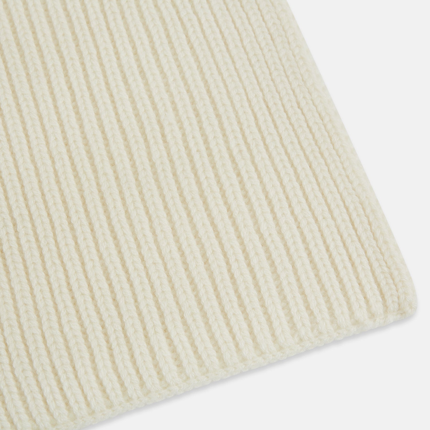 View 2 of product The Turnbull & Asser Ivory Rib-Knit Cashmere Scarf is tied in a simple loop, showing off its textured finish against a plain white background.