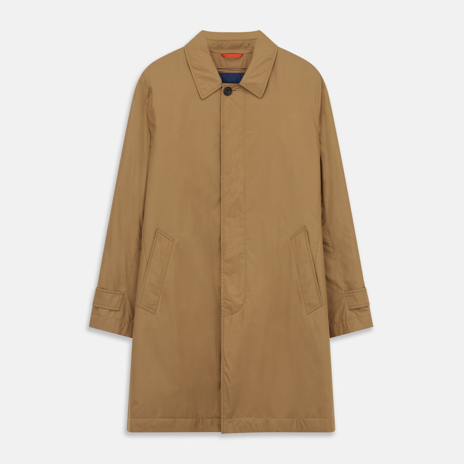 View 2 of product A person wears the Turnbull & Asser Camel Quintern Sealup Raincoat with Detachable Liner, paired with dark pants, standing against a plain light gray background, showing the sleek technical rainwear style with one hand in a pocket.