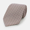 View 1 of product The Turnbull & Asser Navy and Lilac Micro Dot Silk Tie, featuring subtle micro dots, is the perfect refined accessory for smart outfits, shown rolled up against a plain white background.