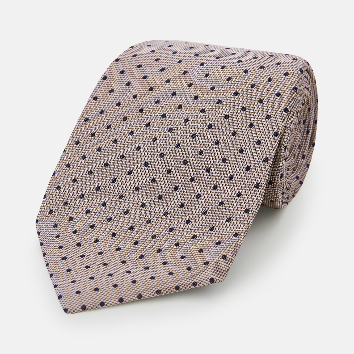 View 1 of product The Turnbull & Asser Navy and Lilac Micro Dot Silk Tie, featuring subtle micro dots, is the perfect refined accessory for smart outfits, shown rolled up against a plain white background.