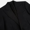 View 2 of product The Turnbull & Asser Black Single Breasted Dinner Suit, with satin lapels and matching trousers, is elegantly folded and displayed on a plain white background.