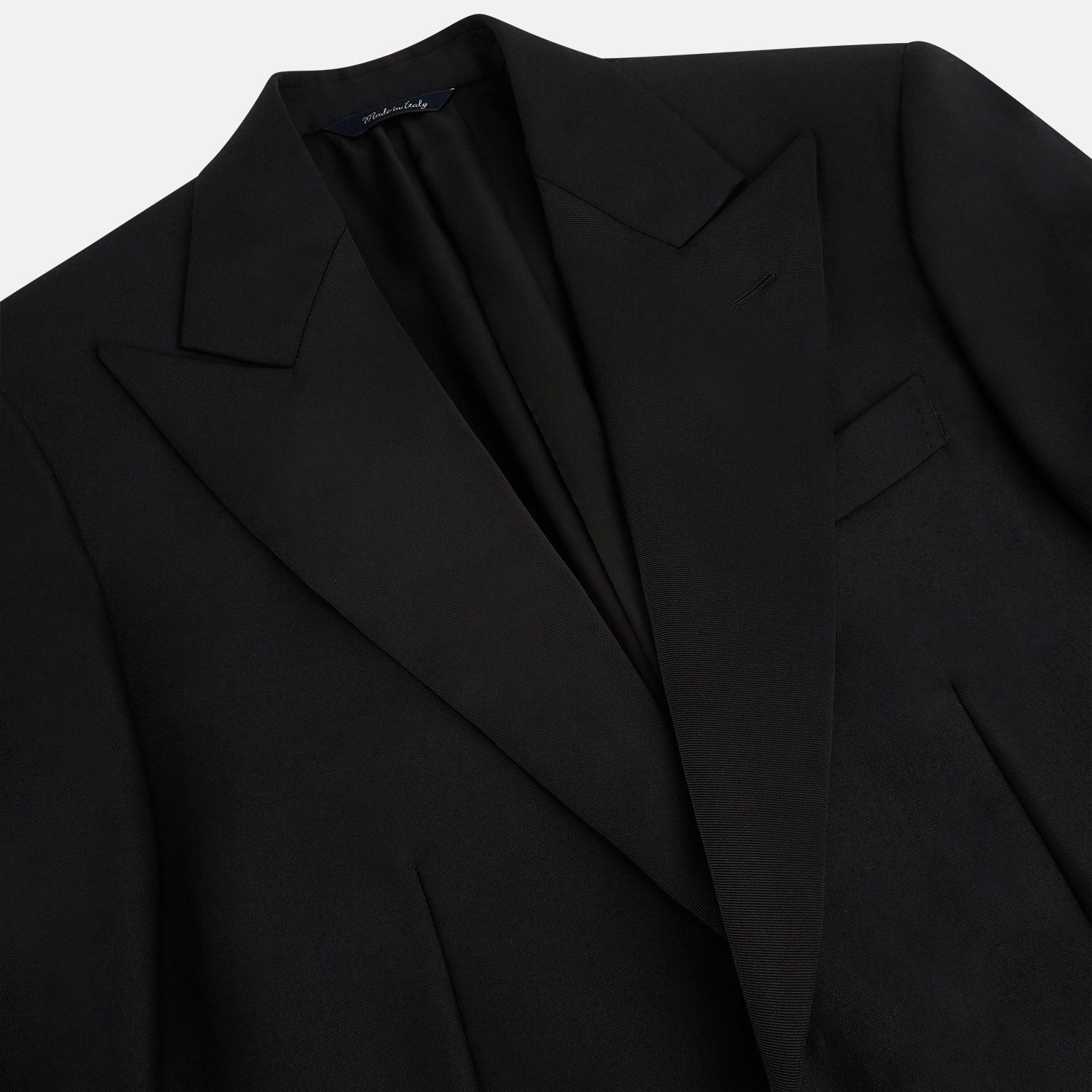 View 2 of product The Turnbull & Asser Black Single Breasted Dinner Suit, with satin lapels and matching trousers, is elegantly folded and displayed on a plain white background.