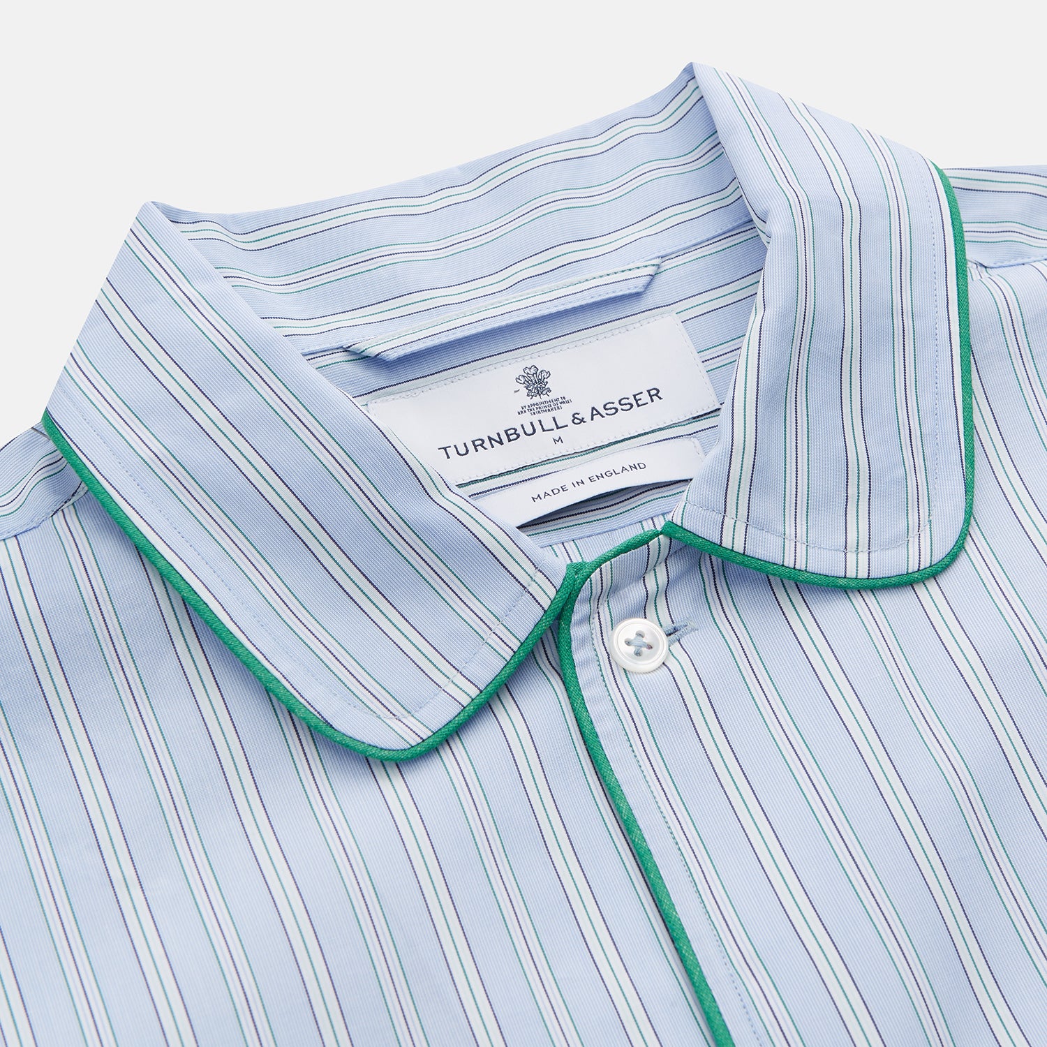 View 2 of product The Turnbull & Asser Blue and Green Stripe Poplin Cotton Nightshirt features long sleeves, a rounded hem, front pocket, green-trimmed collar and pocket, and front buttons—ideal men's nightwear for any season.