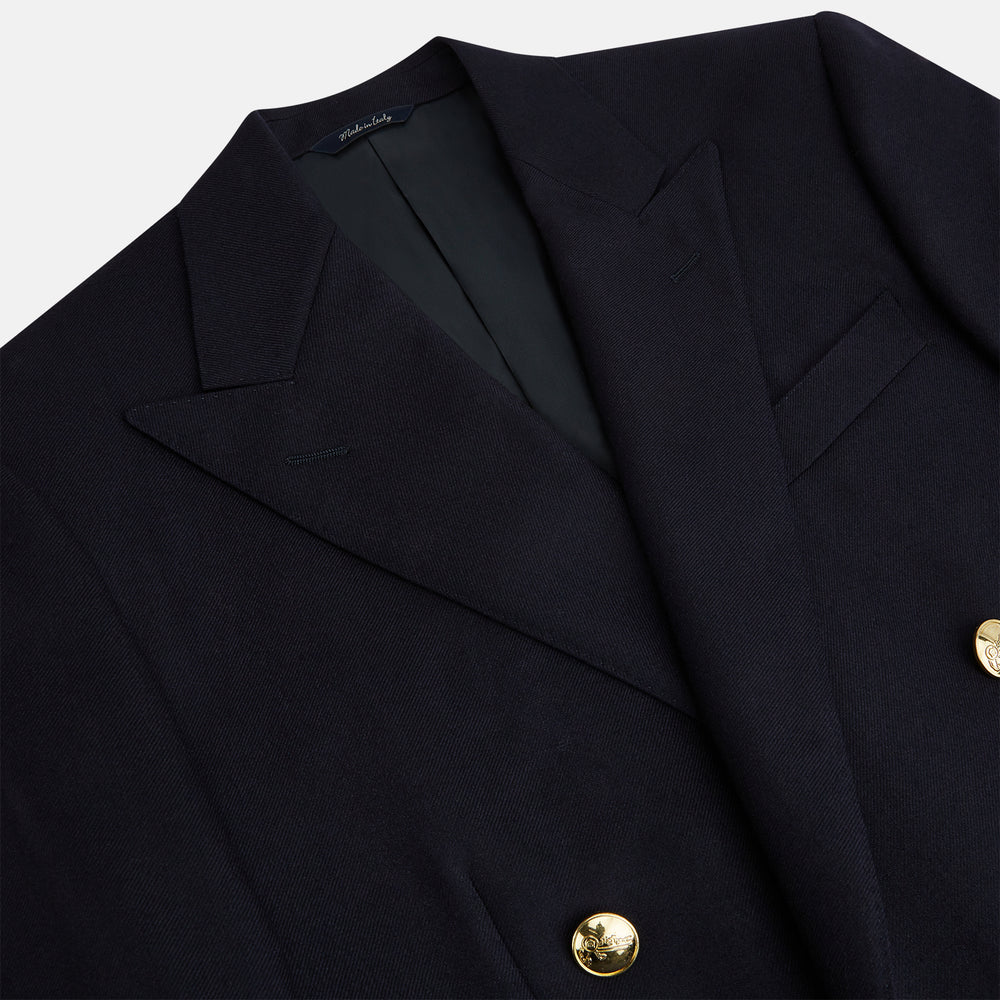 The Turnbull & Asser Short Navy Double Breasted Classic Blazer, featuring gold buttons, peaked lapels, and two front flap pockets, is displayed on a plain white background.