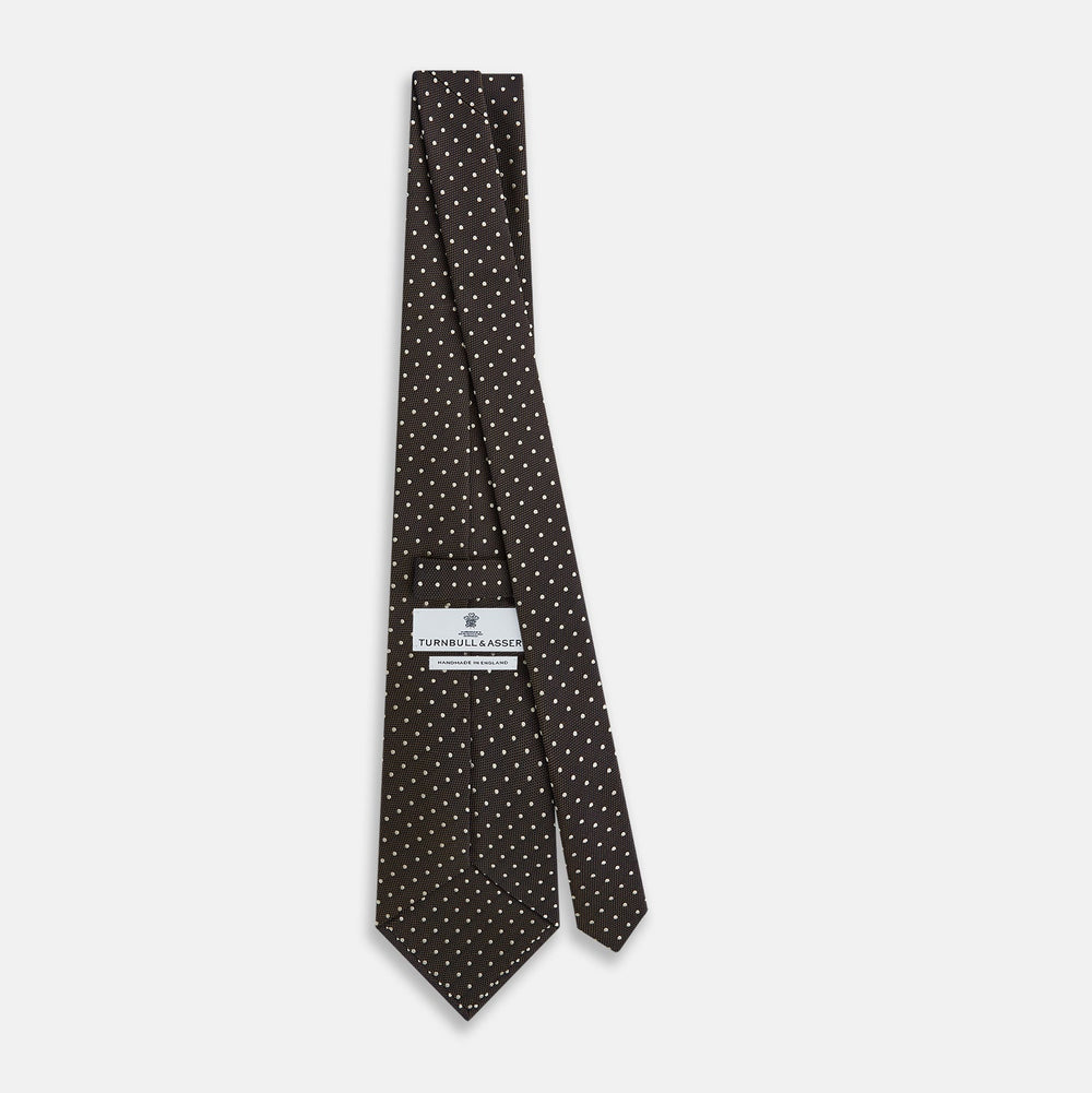 The Turnbull & Asser White and Brown Micro Dot Silk Tie features a refined micro dot pattern—an essential accessory for any men's wardrobe.