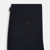 View 5 of product A pair of Midnight Blue Wool Henry Trousers by Turnbull & Asser, with a button closure and straight legs, shown against a plain white background.