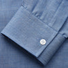 View 2 of product The Turnbull & Asser Blue Cotton Weekend Fit Blake Shirt features a light blue color, long sleeves, stand collar, white buttons, and a curved hem—ideal for casual weekends. Laid flat on a white background.