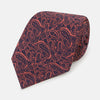 View 1 of product A rolled-up Turnbull & Asser Orange Paisley Silk Tie, featuring an elegant pattern, is displayed against a plain white background.
