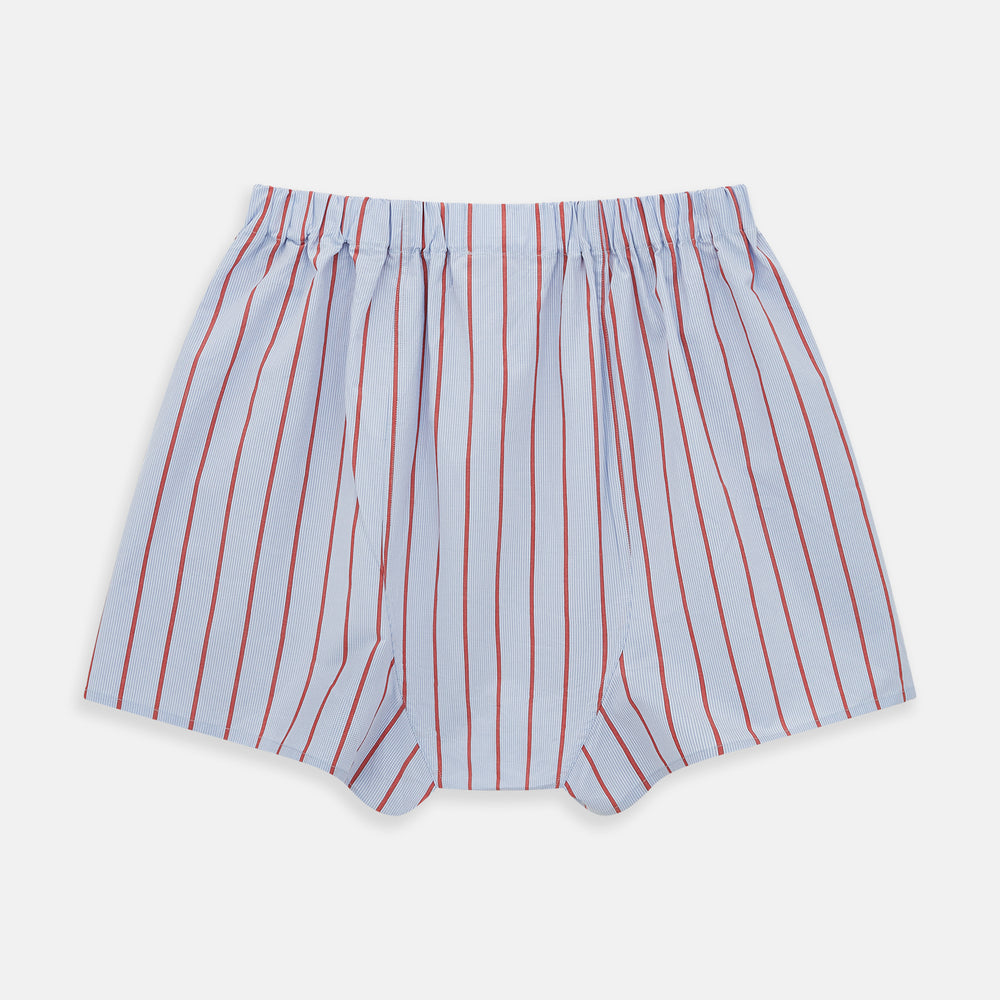 The Turnbull & Asser Pale Blue And Red Pinstripe Godfrey Boxer Shorts feature an elastic waistband and loose fit, made from Italian cotton, shown on a plain white background.