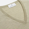 View 2 of product A light green Kennedy Merino V-neck jumper by Turnbull & Asser is laid flat on a white background. This knitwear piece features ribbed cuffs and hem, offering a simple, classic design ideal for any wardrobe.