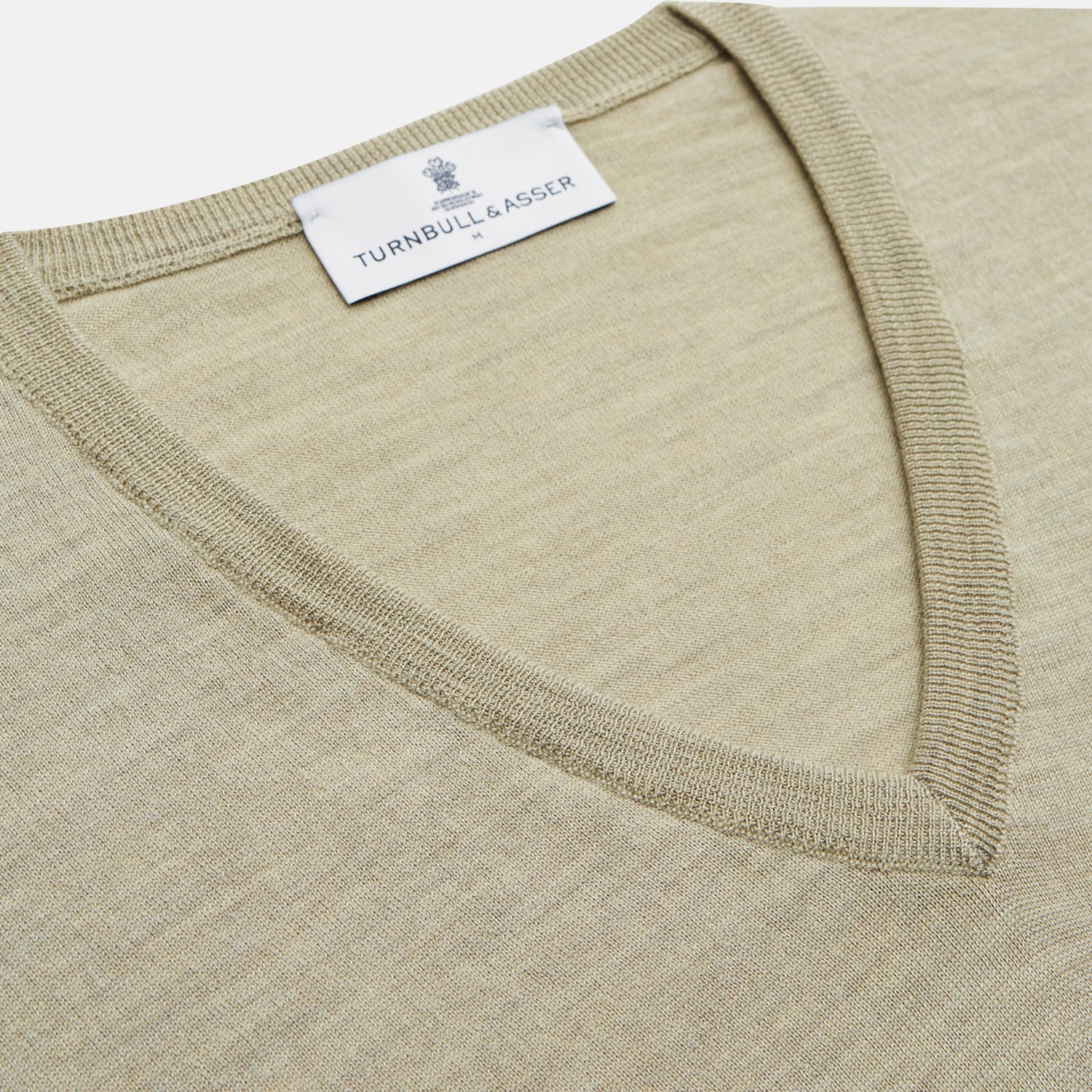 View 2 of product A light green Kennedy Merino V-neck jumper by Turnbull & Asser is laid flat on a white background. This knitwear piece features ribbed cuffs and hem, offering a simple, classic design ideal for any wardrobe.