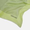 View 2 of product The Melon Green Stripe Silk Pocket Square by Turnbull & Asser features thin vertical black lines on light green silk, neatly folded to display both sides. The lower corner reads “TURNBULL & ASSER HAND PRINTED IN ENGLAND.”.