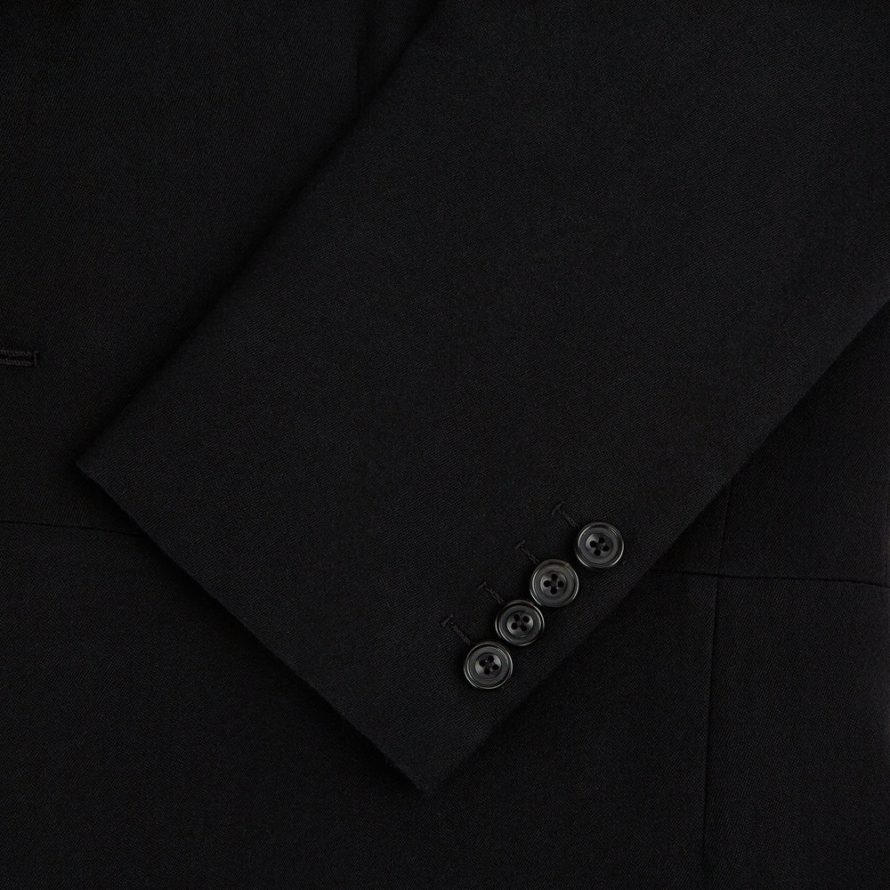 The Turnbull & Asser Black Morning Coat features satin peak lapels, a single front button closure, and long sleeves, shown against a plain white background.