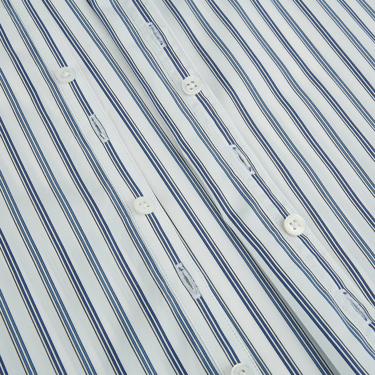 View 7 of product The SAPPHIRE BLUE MULTI TRACK STRIPE WINDSOR SHIRT by Turnbull & Asser features long sleeves, button-up front, classic collar, blue and white vertical stripes, buttoned cuffs, and showcases British craftsmanship on a white background.