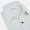 View 2 of product The White Hyde Overshirt by Turnbull & Asser is crafted from sanforised cotton with a left chest pocket and dark buttons—offering a sharp, casual blazer alternative. Shown laid flat on a white background.