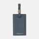 The Blue Leather Luggage Tag by Turnbull & Asser features textured leather, a metal buckle and strap, and displays the logo with "Made in England" printed in white at the bottom.