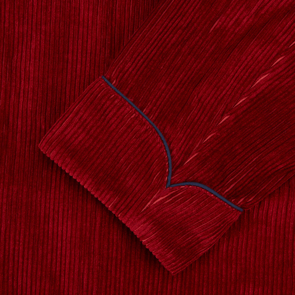 The Turnbull & Asser Burgundy Linen & Cotton Cord Gown, expertly made in England, features a shawl collar, patch pockets, and a matching fabric belt—shown here on a white background.