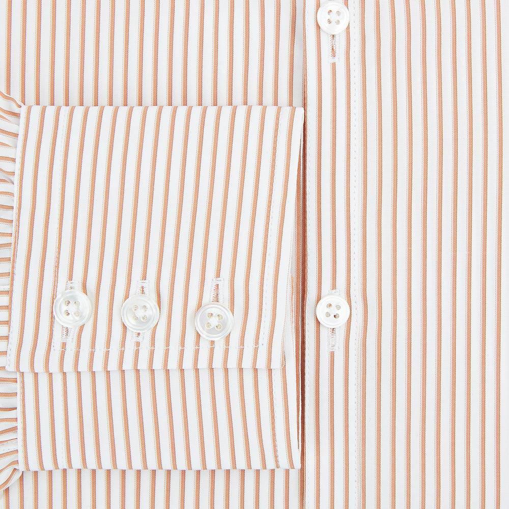 The Orange Multi Stripe Westminster Shirt by Turnbull & Asser features thin vertical orange and white stripes, a Turnbull collar, and long sleeves, elegantly displayed flat against a white background.