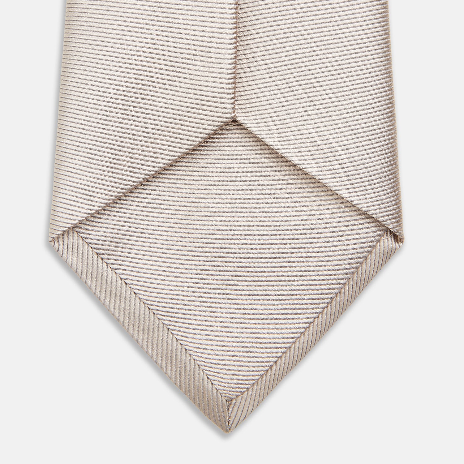 View 4 of product The Turnbull & Asser HORIZONTAL TWILL VELLUM TIE, a light beige silk necktie with a subtle ribbed texture, is shown rolled up on a white background—an essential finishing touch for smart attire.