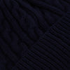 View 2 of product The Turnbull & Asser Midnight Blue Cable Knit Cashmere Beanie features a ribbed folded brim and chunky cable pattern, expertly knitted in England, and shown against a plain white background.