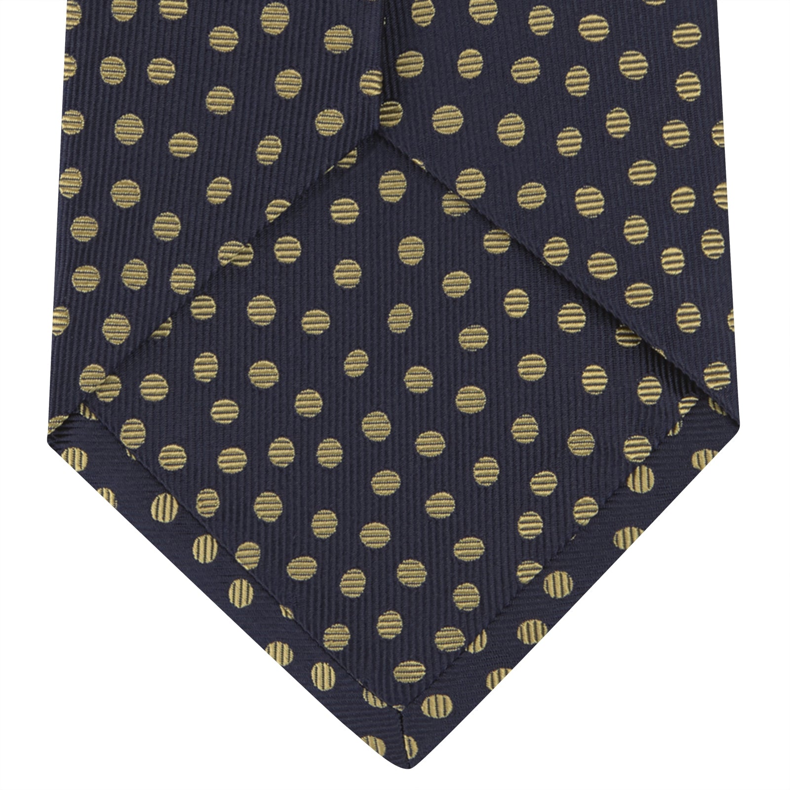 View 4 of product The Turnbull & Asser Navy and Gold Paint Spot Silk Tie features evenly spaced gold spots on classic navy silk, rolled and displayed on a plain white background—ideal for complementing your favorite office shirt.