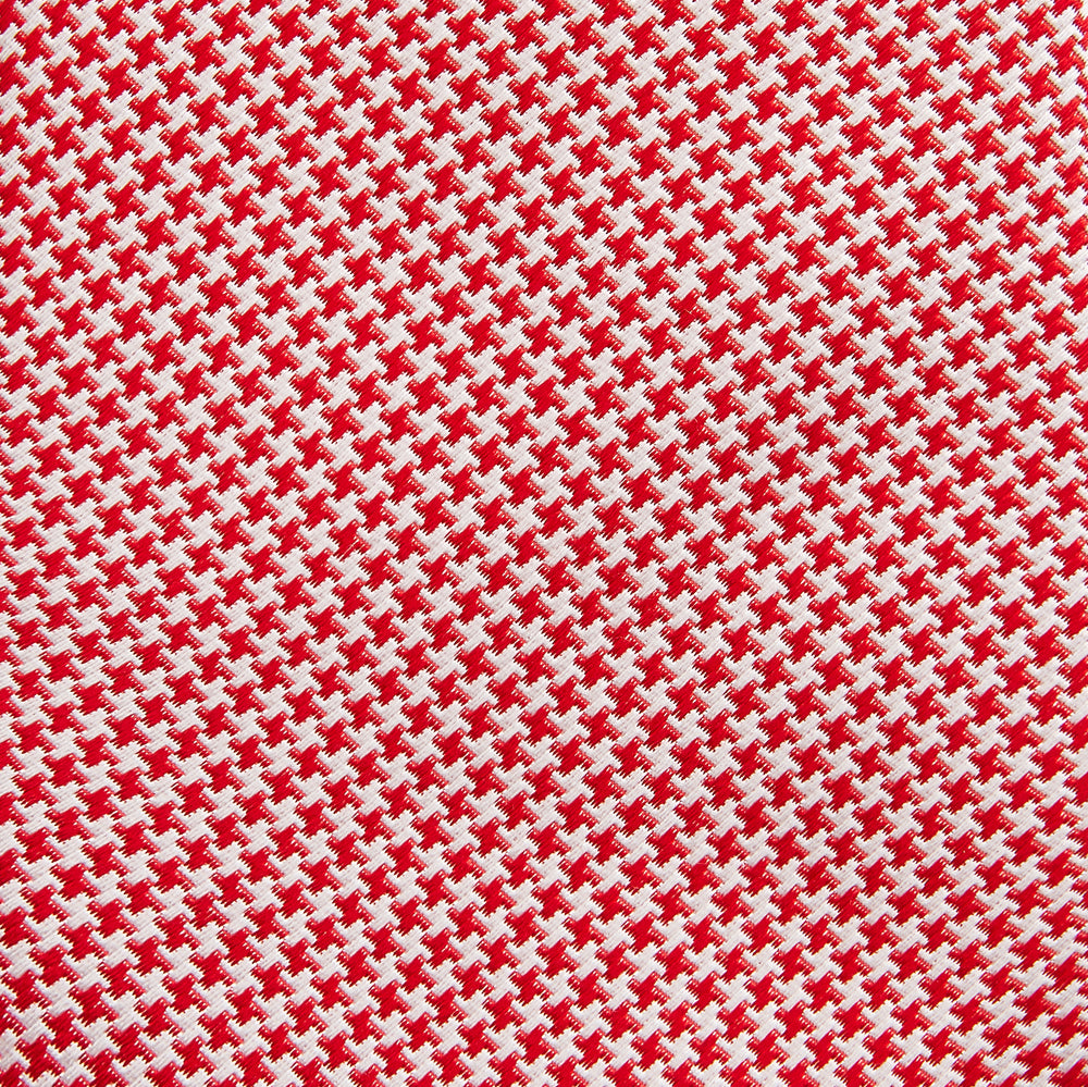 The HOUNDSTOOTH WHITE TULIP RED TIE by Turnbull & Asser features a refined red and white houndstooth pattern—an elegant accessory that elevates any crisp shirt or formal look.