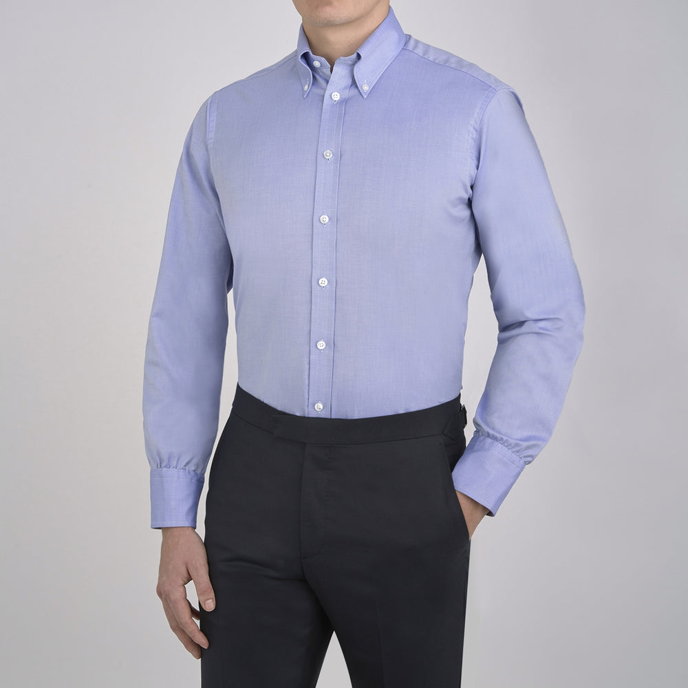 The Turnbull & Asser Blue Royal Oxford Cotton Shirt features a button-down collar, 3-button cuffs, and a visible brand label, shown neatly folded on a white background—ideal for pairing with a navy suit.