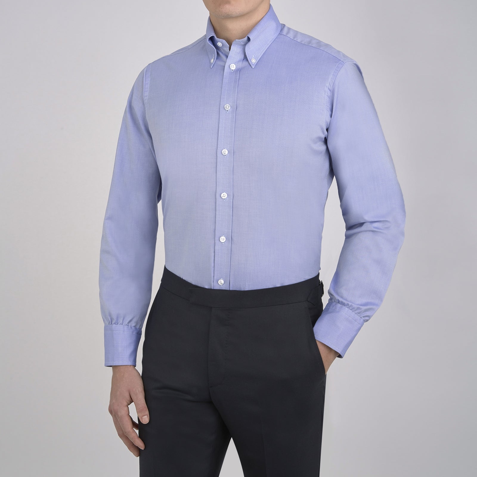 View 4 of product The Turnbull & Asser Blue Royal Oxford Cotton Shirt features a button-down collar, 3-button cuffs, and a visible brand label, shown neatly folded on a white background—ideal for pairing with a navy suit.