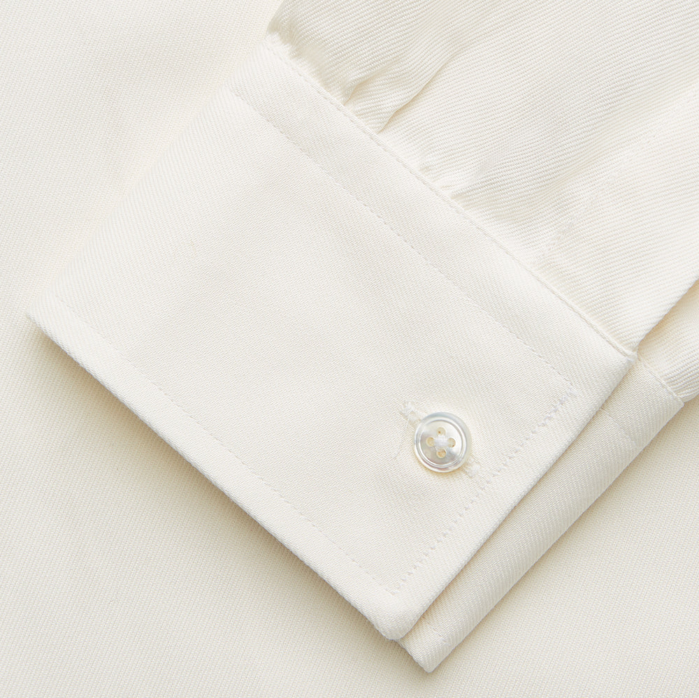 The Turnbull & Asser Cream Weekend Fit Hayne Shirt features a Dorset collar and 1-button cuffs, displayed long-sleeved and laid flat on a white background.
