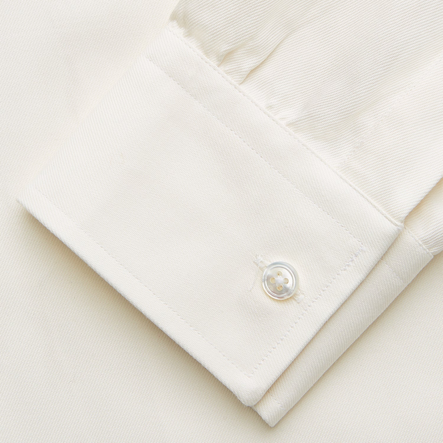 View 4 of product The Turnbull & Asser Cream Weekend Fit Hayne Shirt features a Dorset collar and 1-button cuffs, displayed long-sleeved and laid flat on a white background.