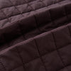View 4 of product The Turnbull & Asser Burgundy Double-Breasted Quilted Gilet is a sleeveless vest with black buttons, an angled front, subtle check pattern, side and chest pockets—an ideal menswear piece for versatile layering.