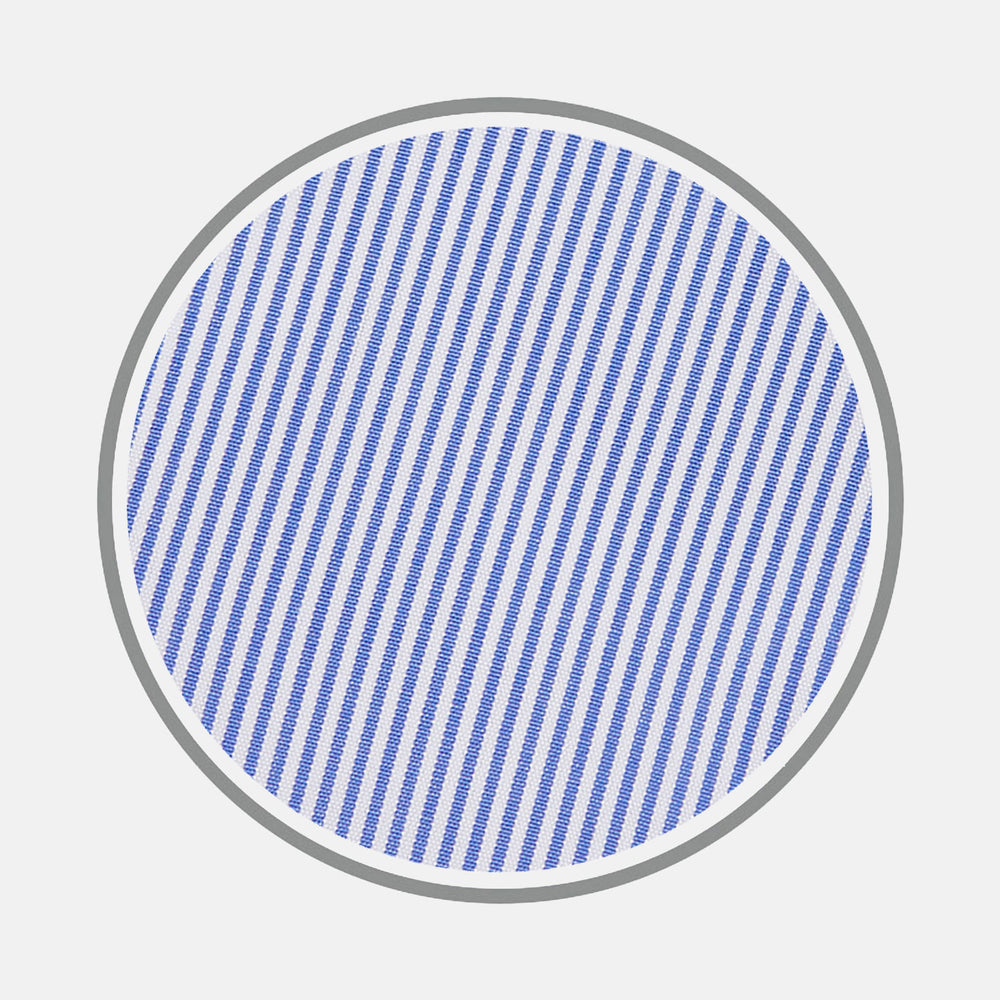 A circle with a gray border features evenly spaced, diagonal blue stripes on a white background, resembling Turnbull & Asser's Blue Fine Bengal Stripe Cotton Fabric. The stripes run from the top left to bottom right.